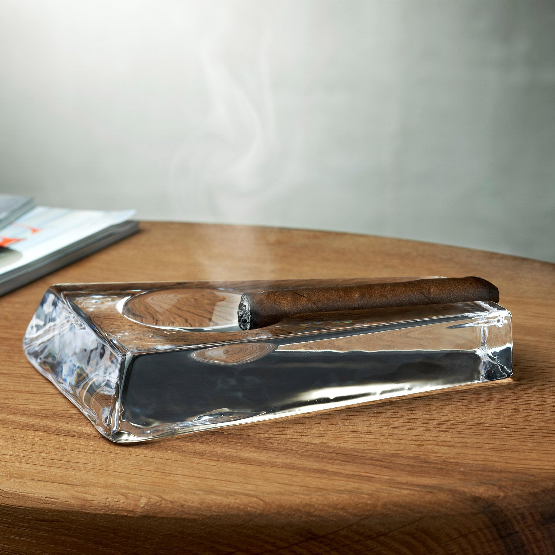 cigarette stick on clear glass ashtray by Nodar Chernishev. Photo stock -  StudioNow