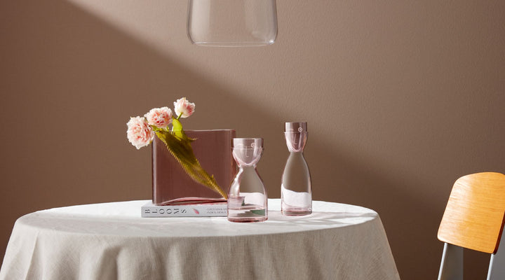 NUDE Mist vase and Mr & Mrs water carafe in Dusty Rose color presented on a table