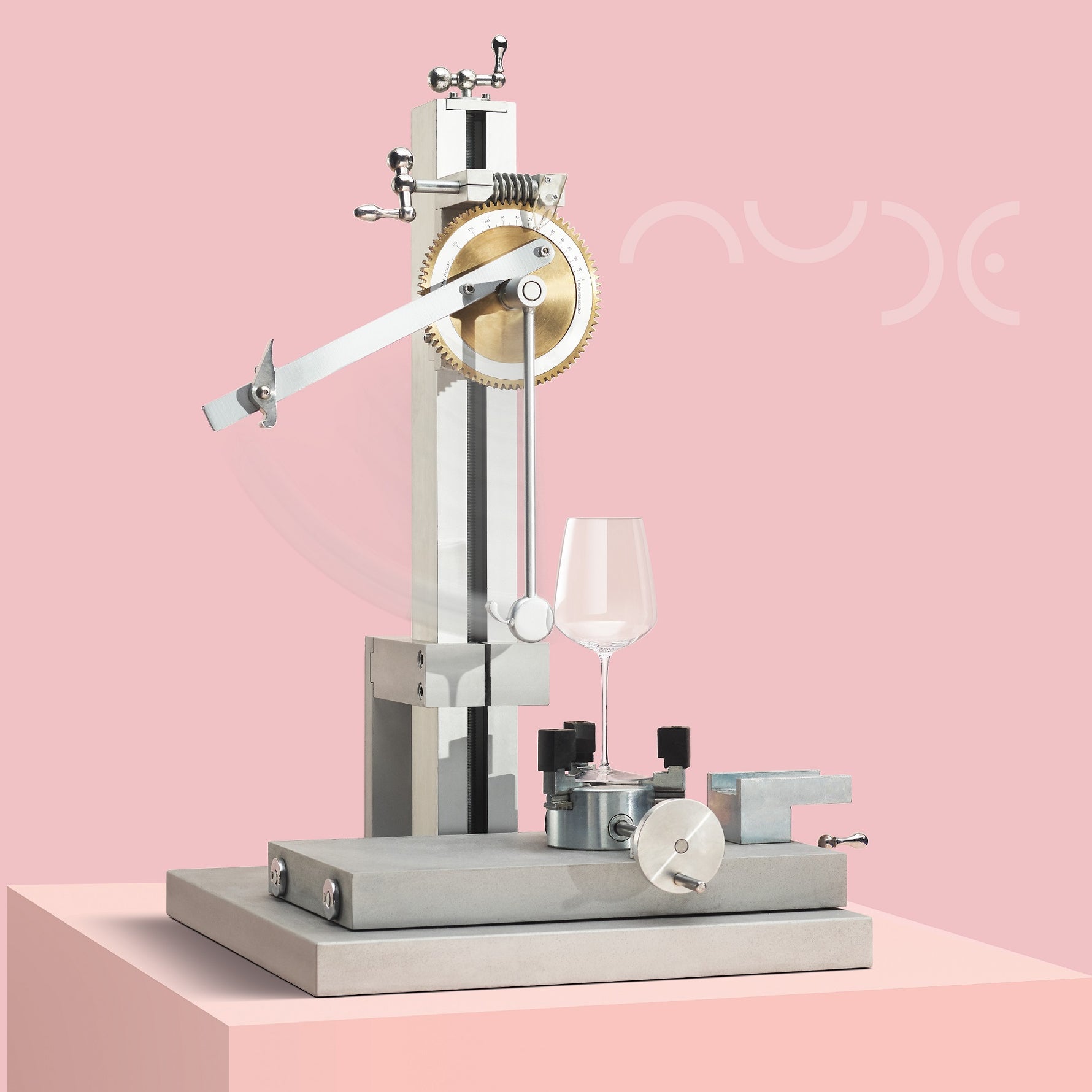 Mechanical device testing the bowl impact  of a glass on a pink background