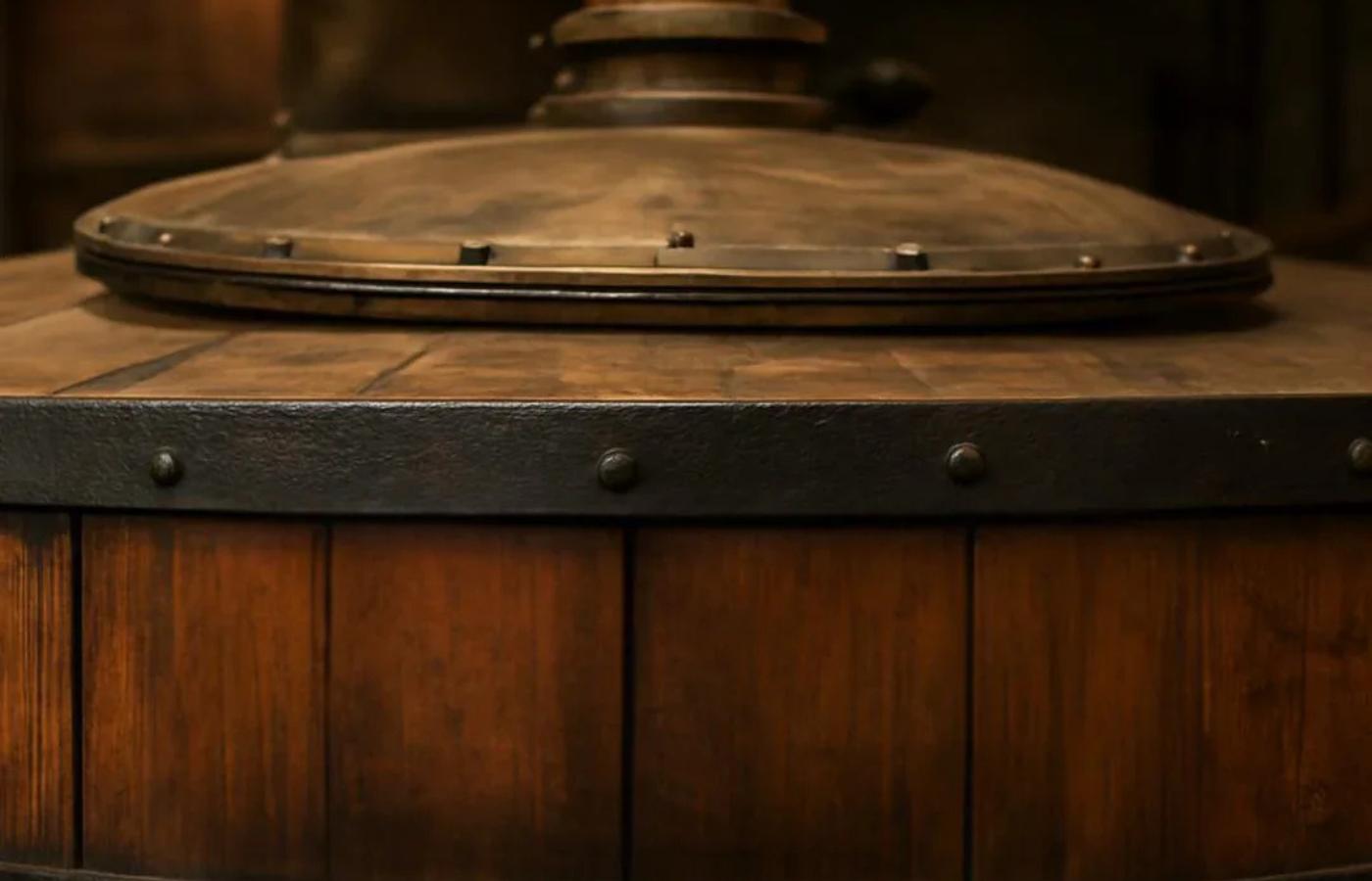 Wooden barrel with a metal lid in a dimly lit setting