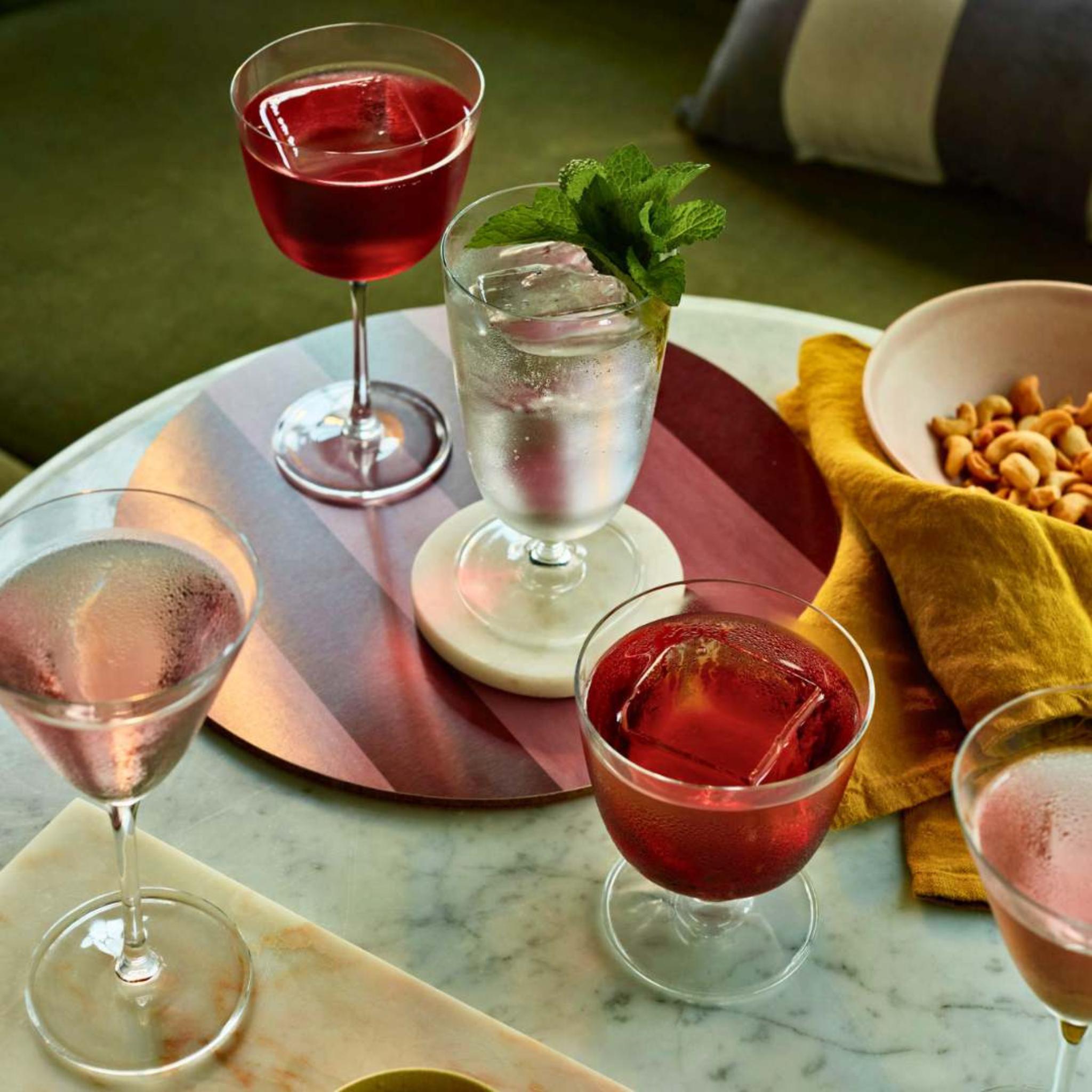 "Cocktails in NUDE Bar/Giani glasses on a bar table: Cocktail Glass Long Stem, Cocktail Glass Short and Martini Glass.