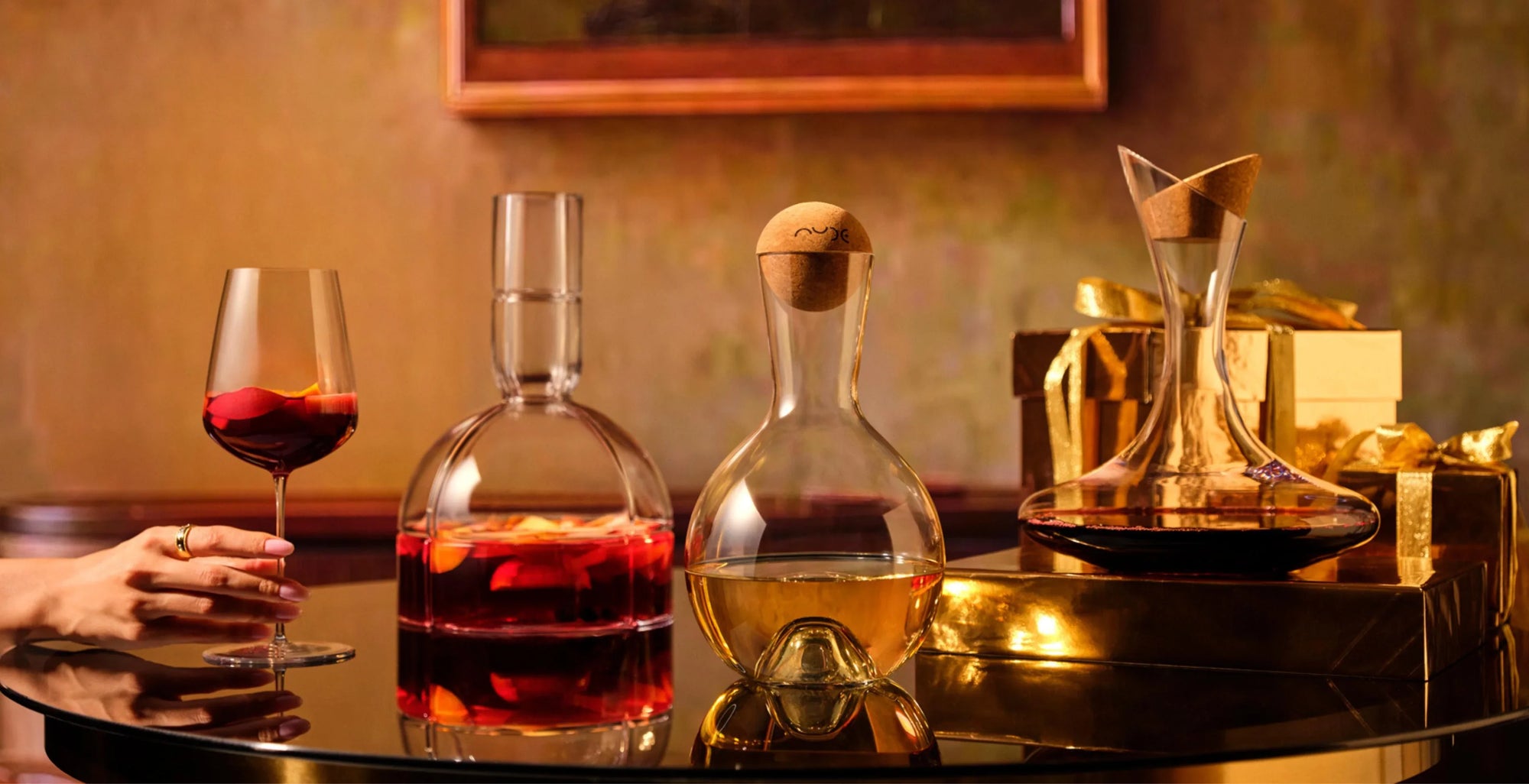 NUDE Wine decanters O2, Vintage Decanter with cork stopper and Oxygen Decanter with cork stopper in lead-free crystal presented  on a table with a warm background with the holiday gift guide mood