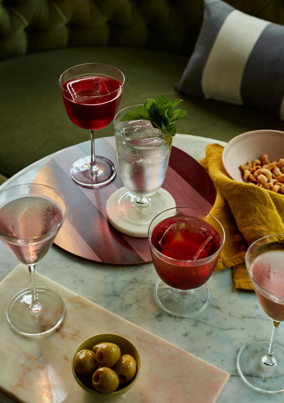"Cocktails in NUDE Bar/Giani glasses on a bar table: Cocktail Glass Long Stem, Cocktail Glass Short and Martini Glass.
