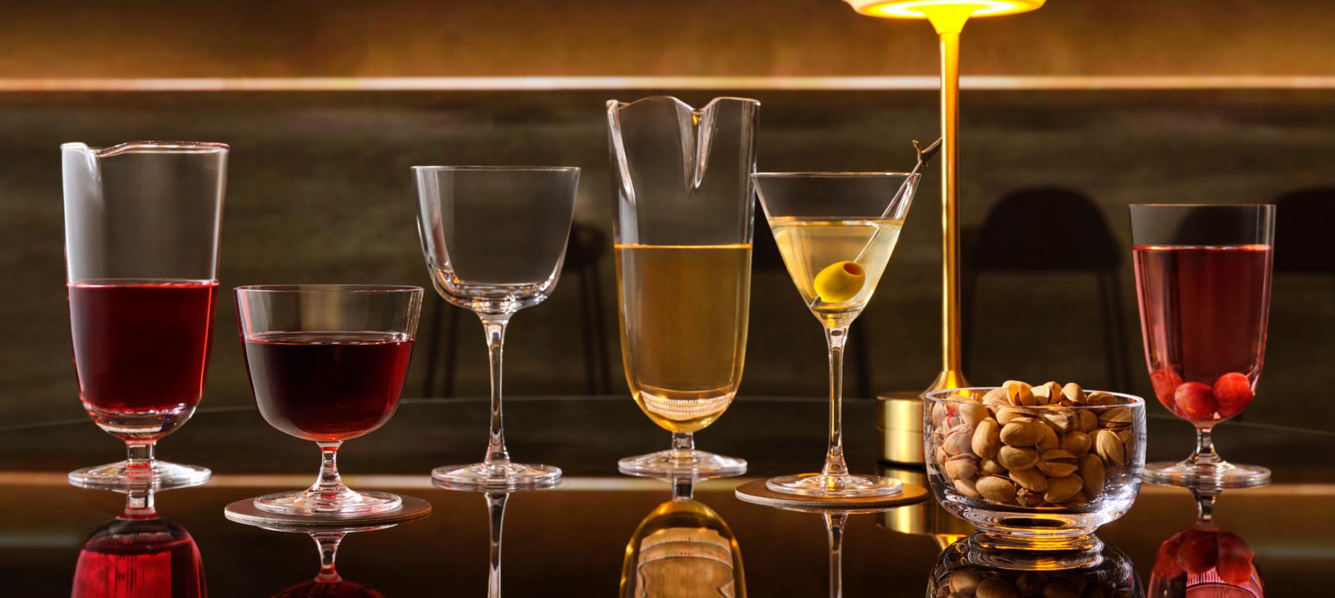 The NUDE Bar/Giani collection on a bar: Double Pour Mixing Glass, Cocktail Glass Short, Cocktail Glass Long Stem, Cocktail Glass Long and Martini Glass