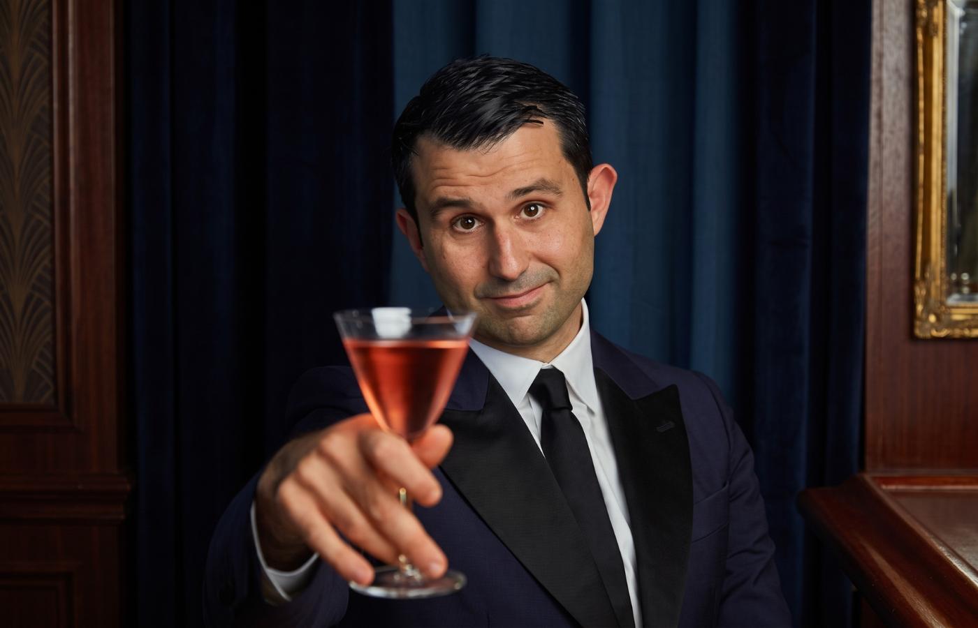 Giorgio Bargiani raising a rose-coloured martini in a NUDE Bar/Giani Martini Glass