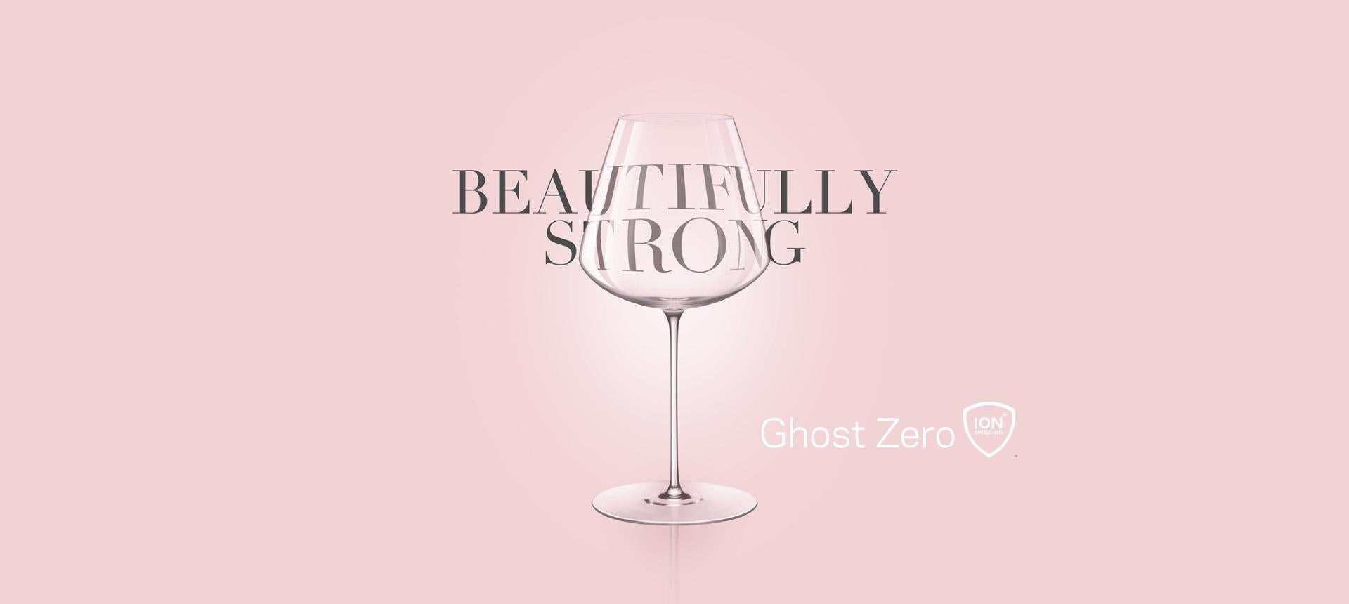 NUDE Ghost Zero wine glass on a soft pink background with the words Beautifully Strong and the Ion Shielding Technology logo