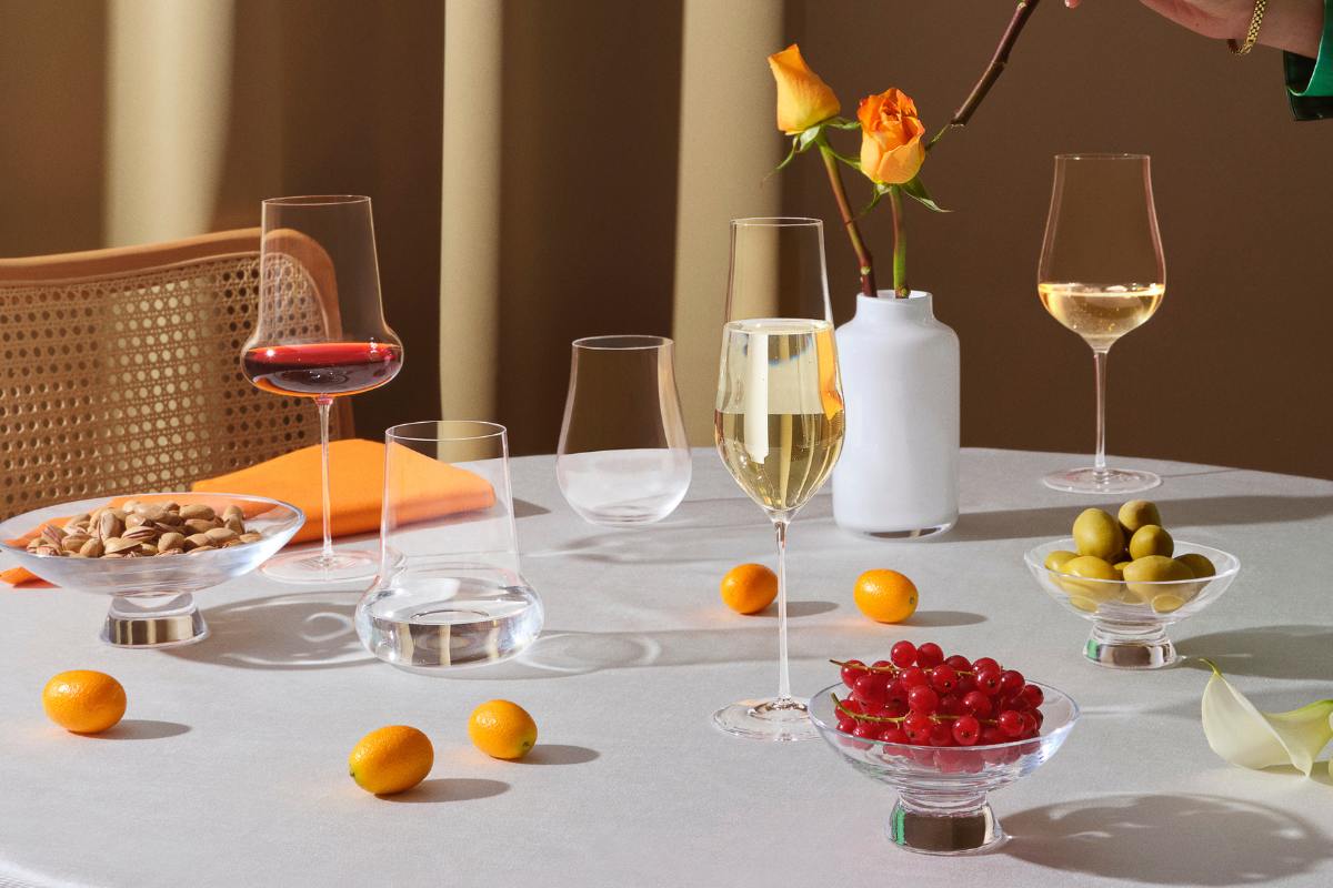 NUDE Ghost Zero Belly and Tulip glasses with Silhouette bowls on an elegant white table setting, red wine being poured