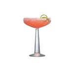 NUDE Big Top Coupe glass with linear patterned stem filled with cocktail