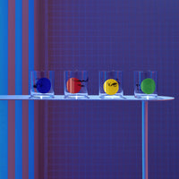 Lifestyle image of NUDE Rock & Pop glass collection with jug, highball glass and whisky glass in dark neon environment