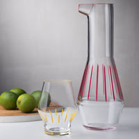 Beak Waterglass Iris collection Yellow presented together with Beak Water carafe red striped